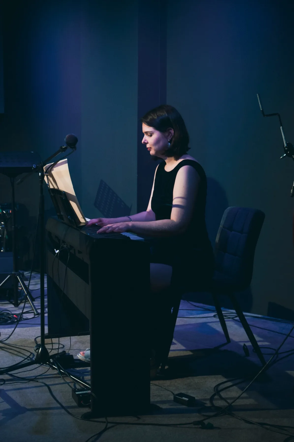 Alina playing piano on stage